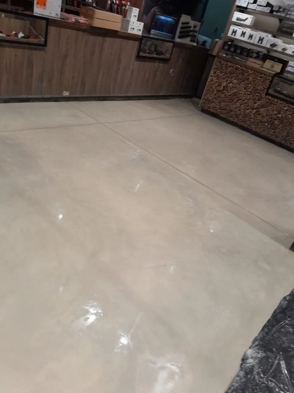 Shop with a glossy pale grey epoxy floor in front of the counters
